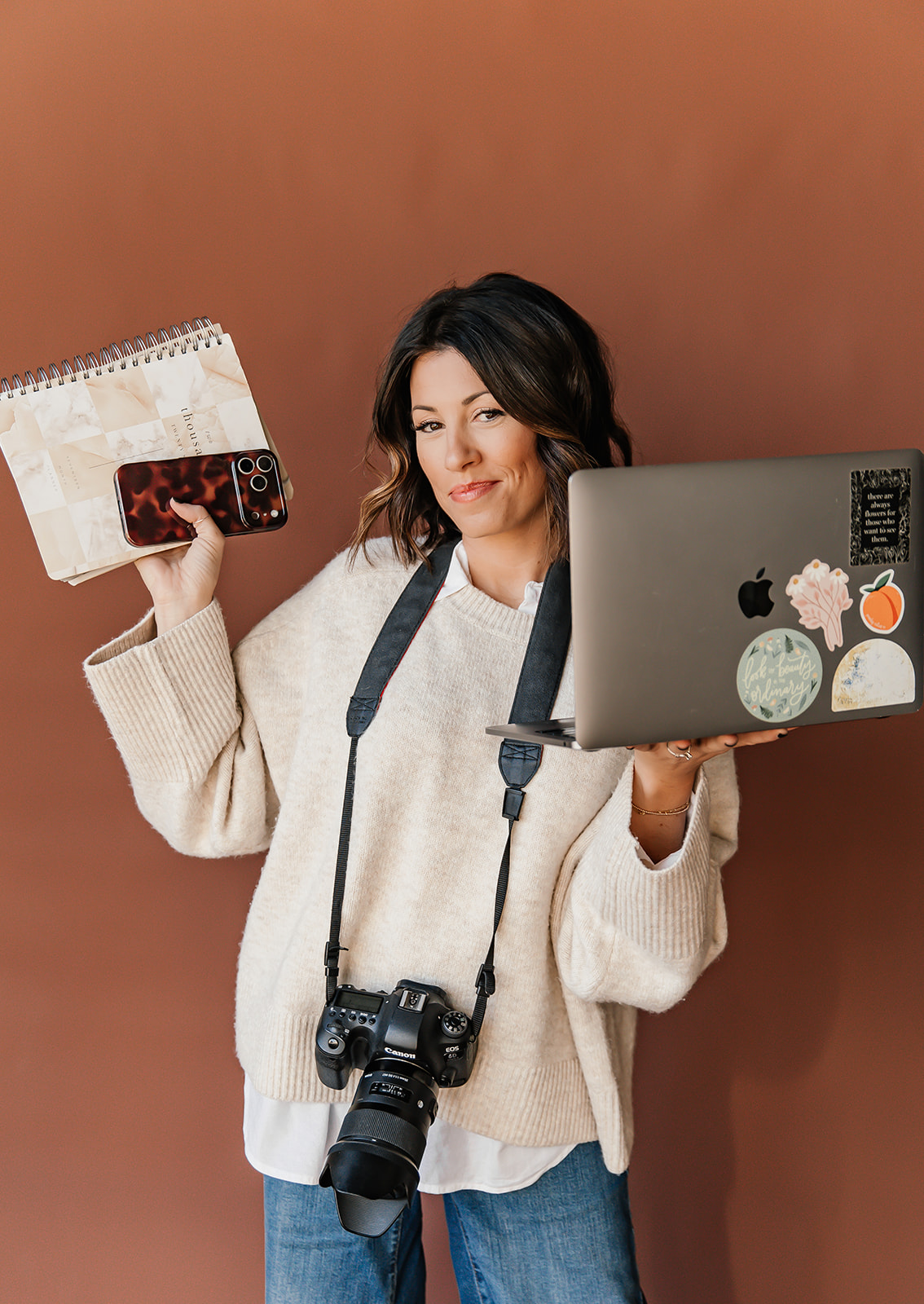 Lindsey wearing all the hats - camera, laptop, phone, planner